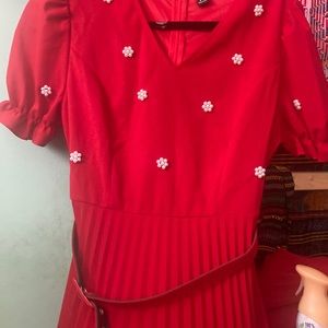 A red dress with pearl flowers🤗it’s got a belt with it size M